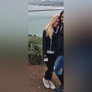 black leather jacket with gray hoodie stitched inside